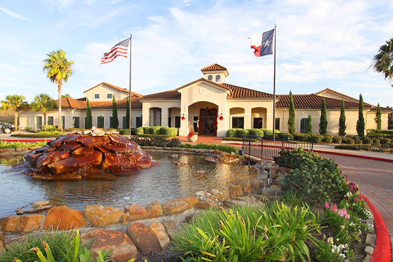 View of the water feature and landscaping outside the clubhouse at Bellavita at Green Tee in Pearland, Texas