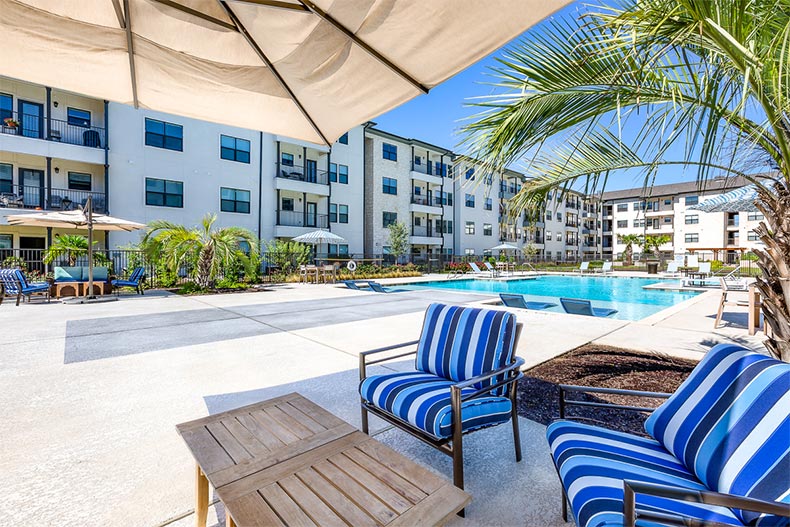 View of the outdoor pool and patio at Soléa Cedar Park in Cedar Park, Texas