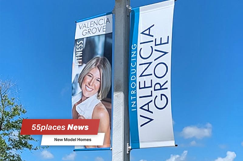 "New Model Homes" banner over a pole with a promotional banner for Valencia Grove at Riverland in Port St Lucie, Florida