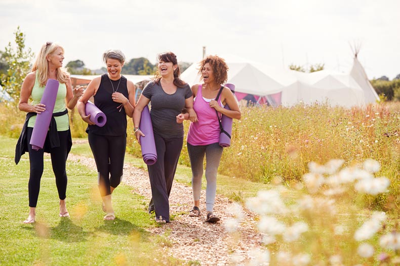 A group of mature female friends attending a yoga class in a 55+ community