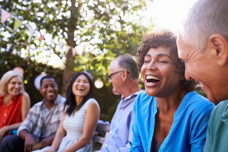 A group of mature friends socializing in a 55+ community together