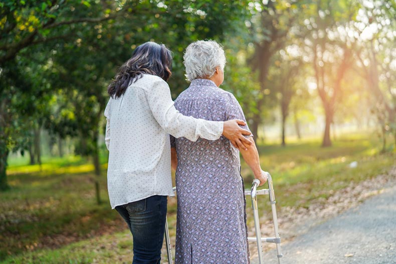 An elderly woman going for a walk with a younger woman in a 55+ community