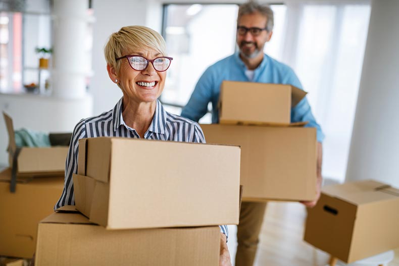 A happy senior couple moving into a new home