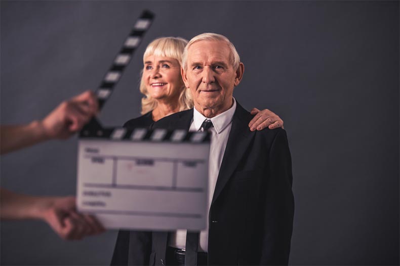 An older couple waiting for a director to should action.