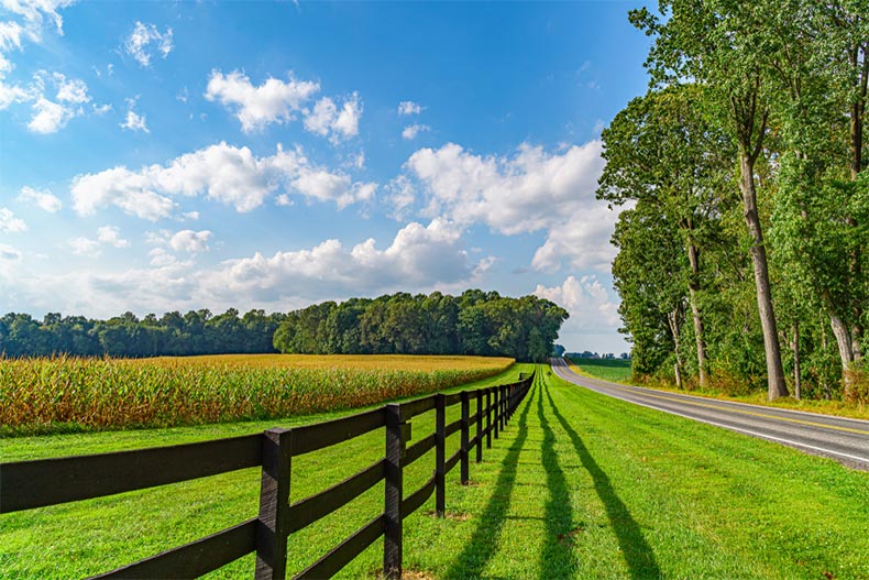 An Amish Country field with a wooden fence beside a road in Lancaster, Pennsylvania