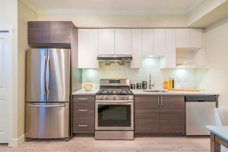 A modern kitchen interior with stainless steel appliances in a luxury house