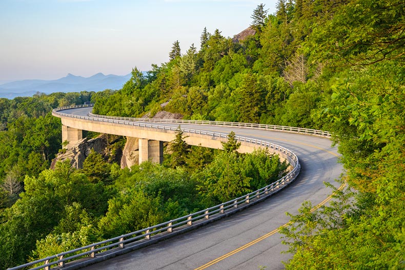 An elevated highway winding through the mountains along The Blue Ridge Parkway