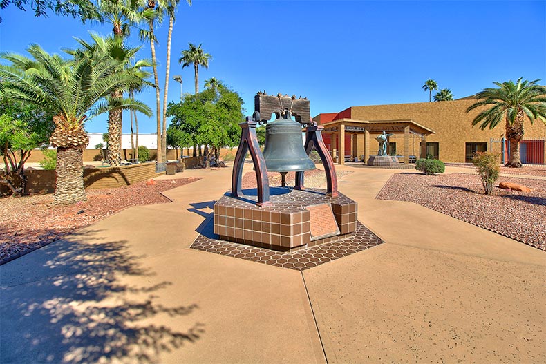 A historic bell on a walking path at Sun City in Sun City, Arizona