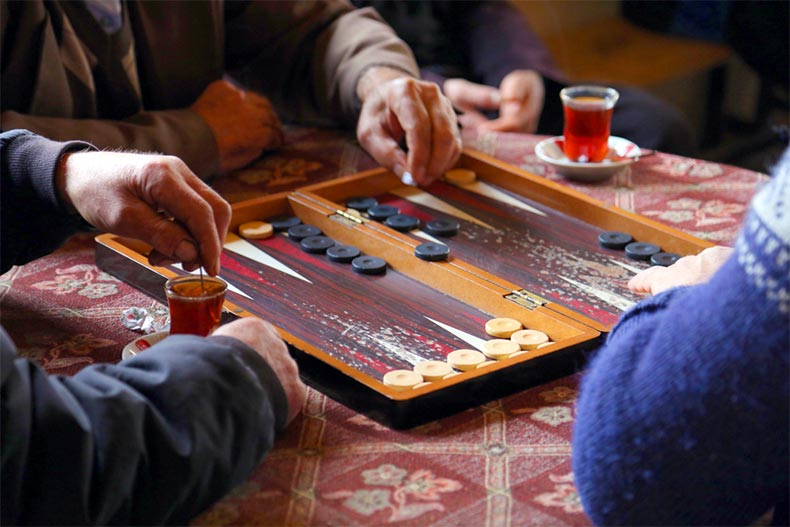 People playing a game of backgammon