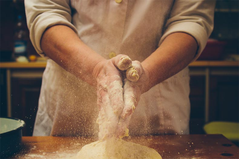 Man baking and using flour