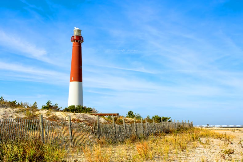 View of the red and white Barnegat Lighthouse on a beach in Long Beach Island, New Jersey