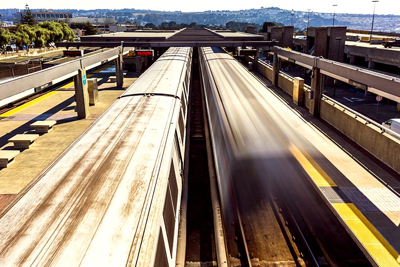 Overheard shot of two BART trains leaving a station in San Francisco, California