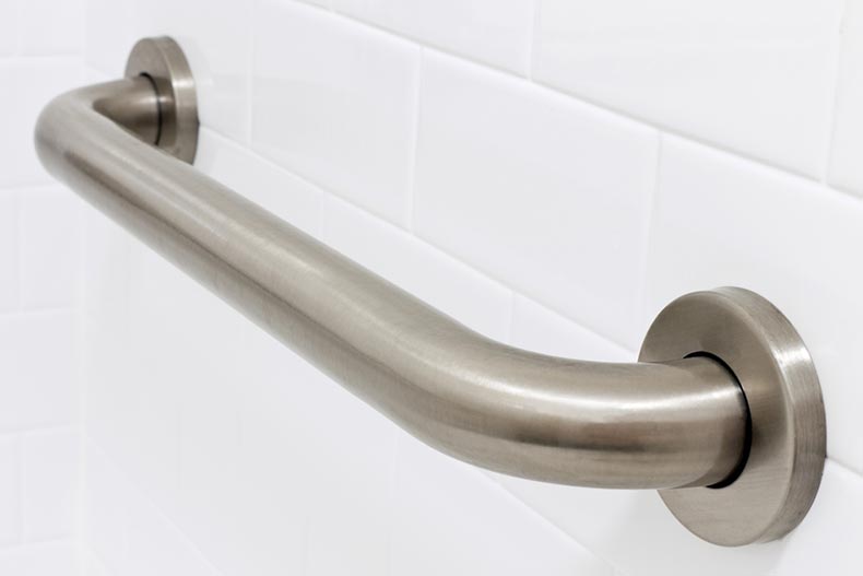 A grab bar handrail in a handicapped access bathroom