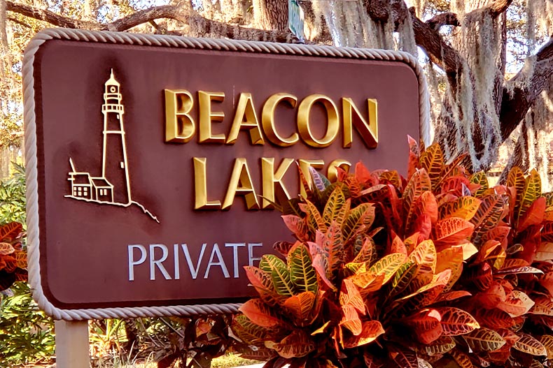 Photo of the welcome sign at Beacon Lakes in New Port Richey, Florida with shrubbery blocking some letters