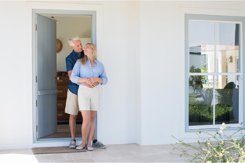 A happy active adult couple embracing after closing on their new home