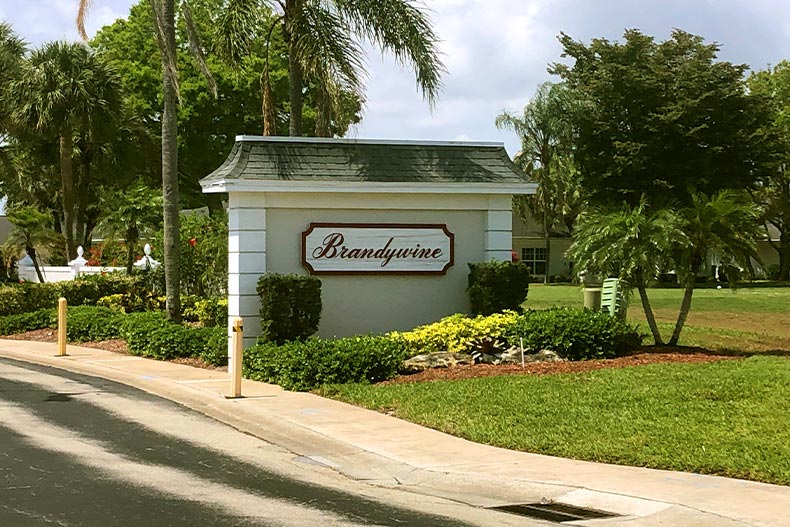 A welcome sign in Brandywine surrounded by various trees, located in Fort Myers, Florida
