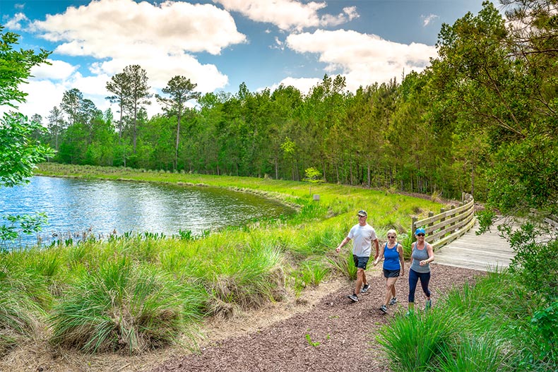 Residents walking along a nature trail in Brunswick Forest in Leland, North Carolina