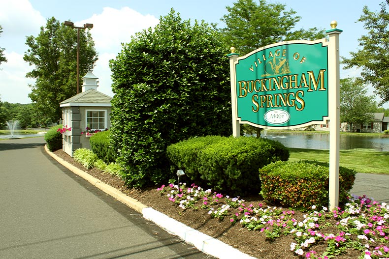 View of a welcome sign and gate house located in Village of Buckingham Springs, New Hope, Pennsylvania