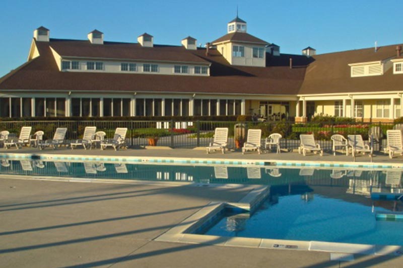 View of the clubhouse at Carillon Lakes with the outdoor pool and patio in the background.