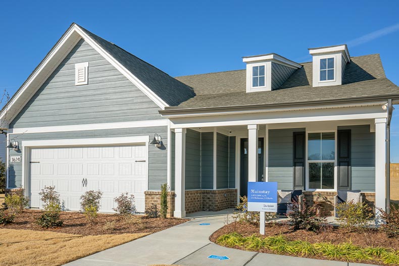 Exterior view of a gray model home in Del Webb Carolina Gardens, located in Fuquay-Varina, North Carolina