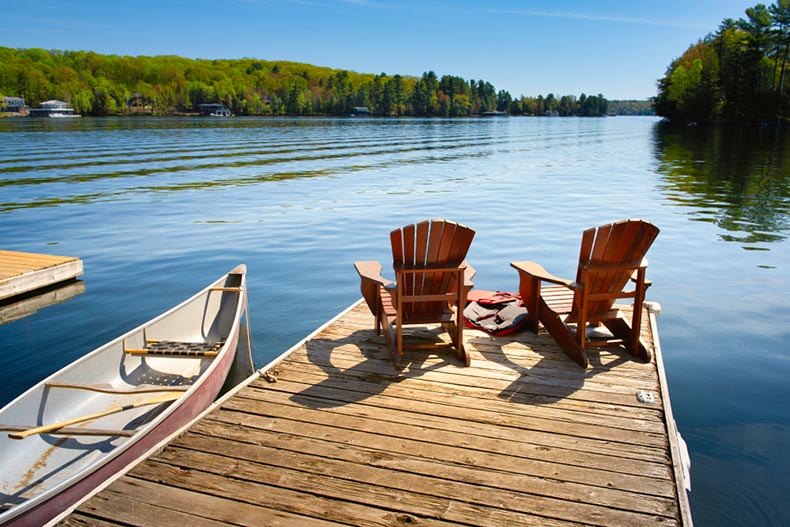 Two Adirondack chairs on a wooden dock in Ontario, Canada