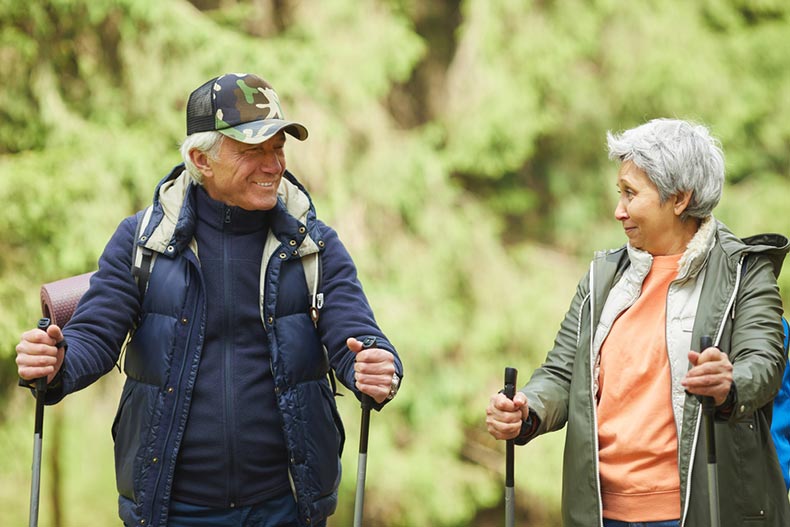 A cheerful senior couple enjoying a hike in their 55+ community