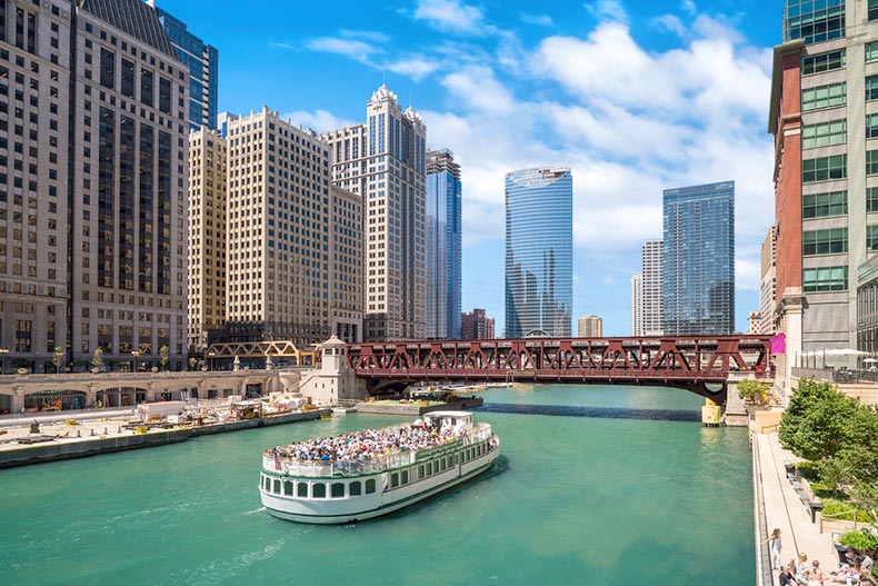 A tour boat cruising down the Chicago River through the heart of downtown Chicago