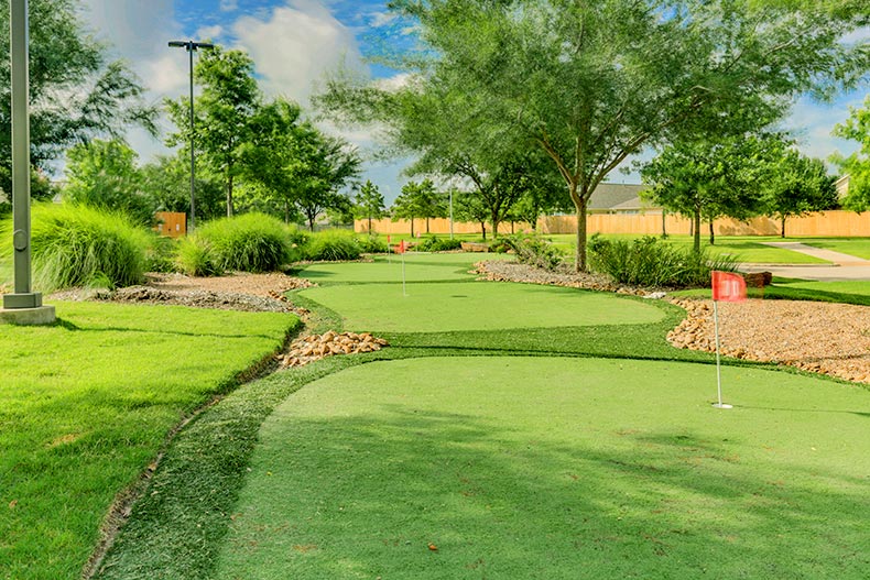 Several holes of a putting green in Heritage Grand at Cinco Ranch in Katy, Texas