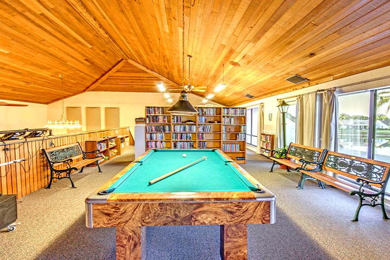 A billiards hall with bookshelves and park benches, located in Cinnamon Cove in Fort Myers, Florida