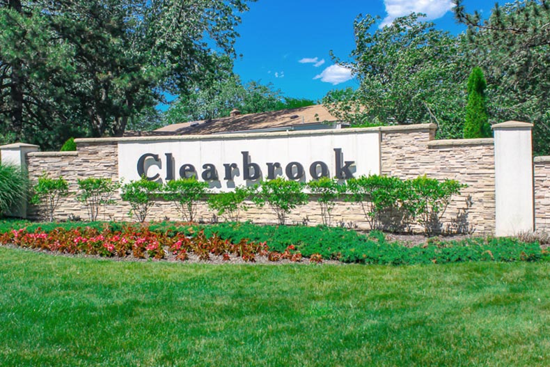 Greenery surrounding the community sign for Clearbrook in Monroe, New Jersey