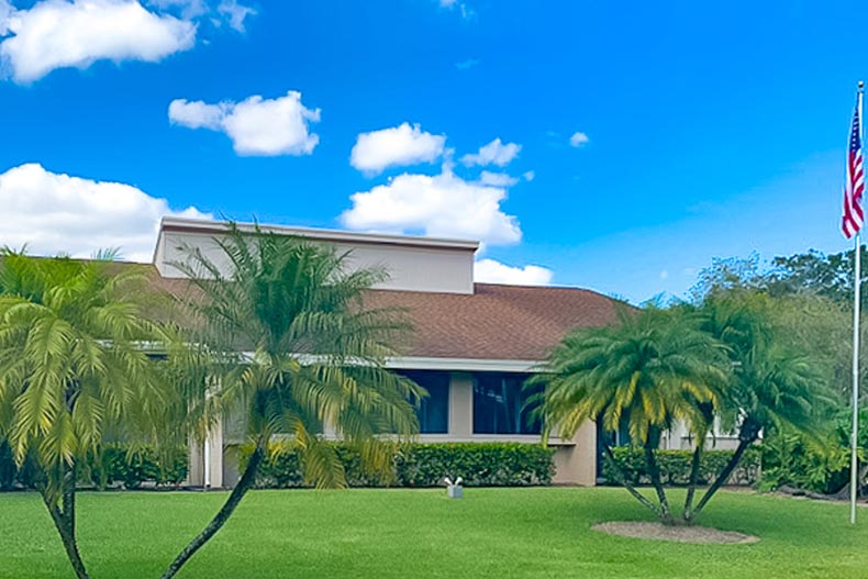 Palm trees outside a community building at Coco Wood Lakes in Delray Beach, Florida