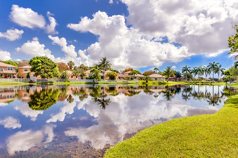 A lake in Coconut Creek, Florida surrounded by houses and white clouds