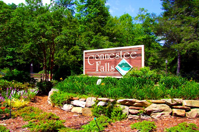 The community sign at Connestee Falls surrounded by greenery, located in Brevard, North Carolina
