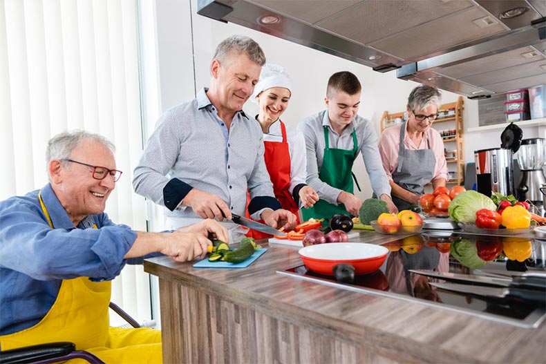 Participants learning to cooking in a demonstration kitchen