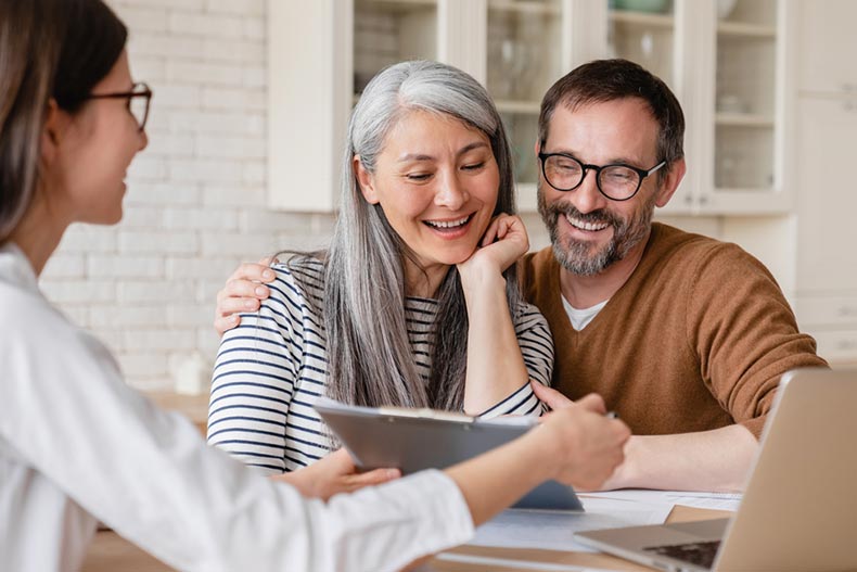 A financial advisor helping a mature couple at home