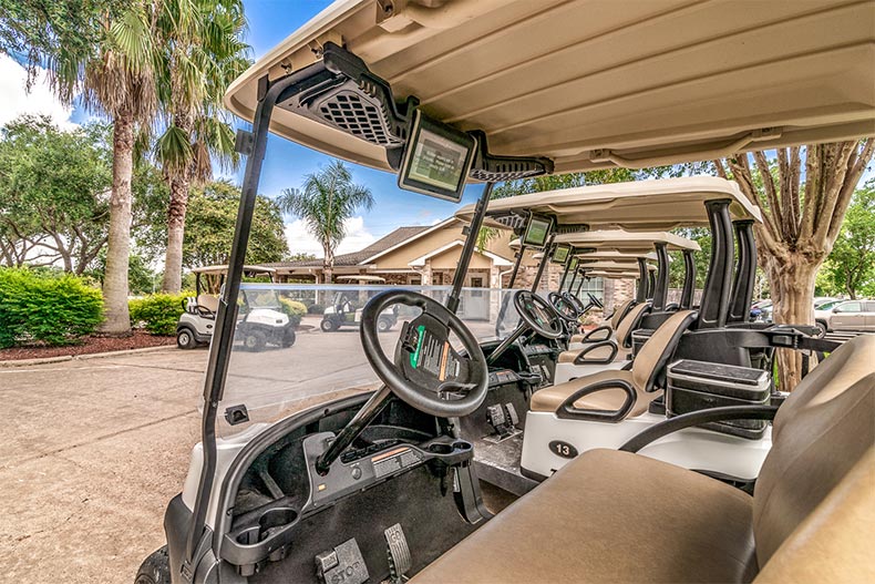 A line of golf carts outside the golf club at CountryPlace in Pearland, Texas