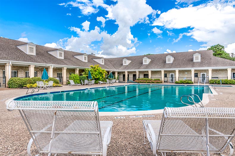 Lounge chairs beside the outdoor pool at CountryPlace in Pearland, Texas