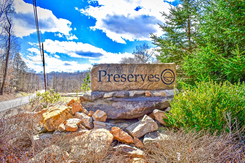 Rocks and greenery surrounding the community sign for Courtyards at The Preserves in McDonald, Pennsylvania