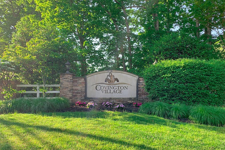 Greenery surrounding the community sign for Covington Village in Lakewood, New Jersey