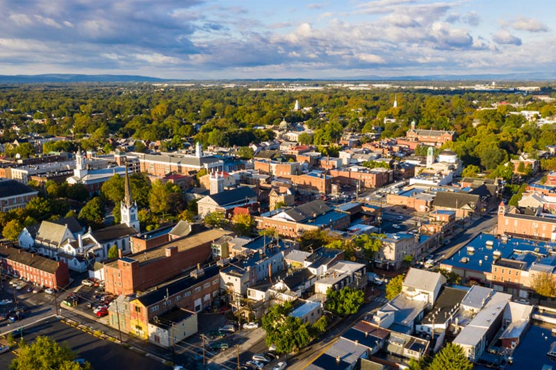Aerial view of Carlisle, PA with a partly cloudy sky.