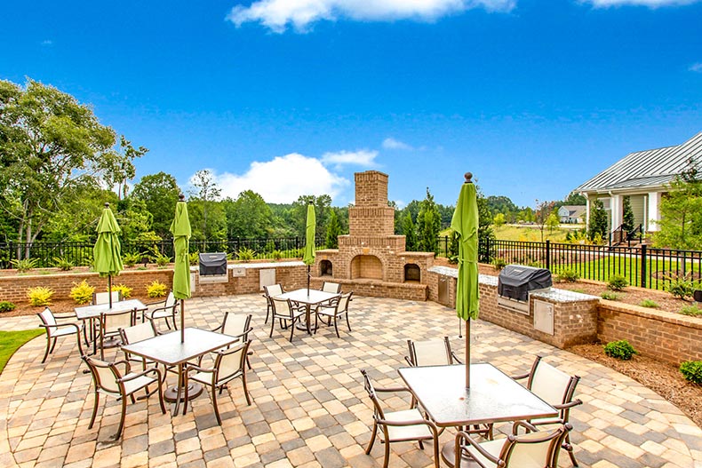 Tables and chairs on a patio at Cresswind Charlotte in Charlotte, North Carolina