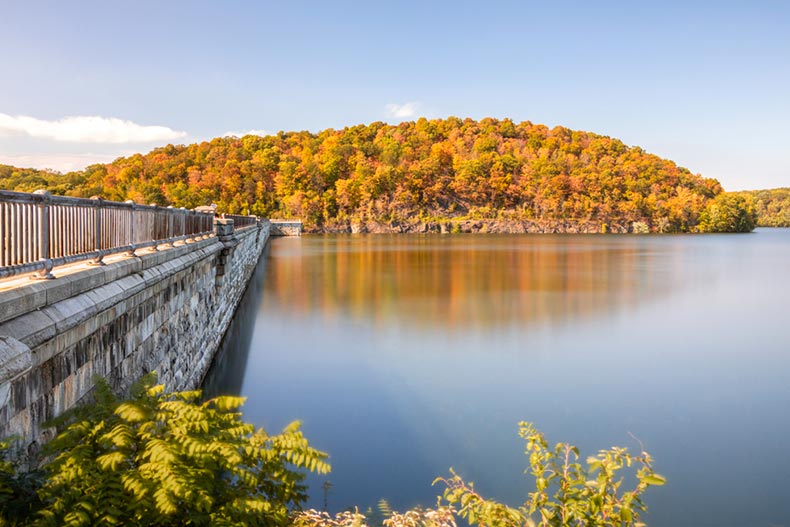 Fall foliage reflecting on a calm lake at Croton Gorge Park in New York