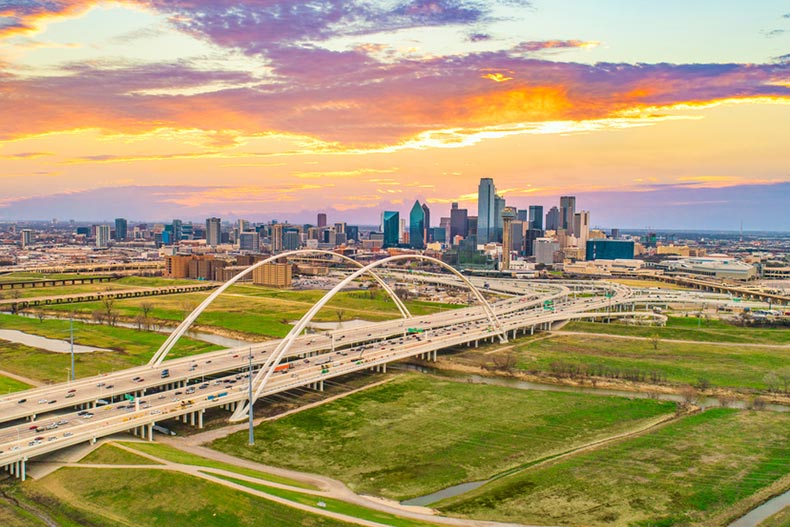 Aerial view of a bridge in front of the Dallas skyline