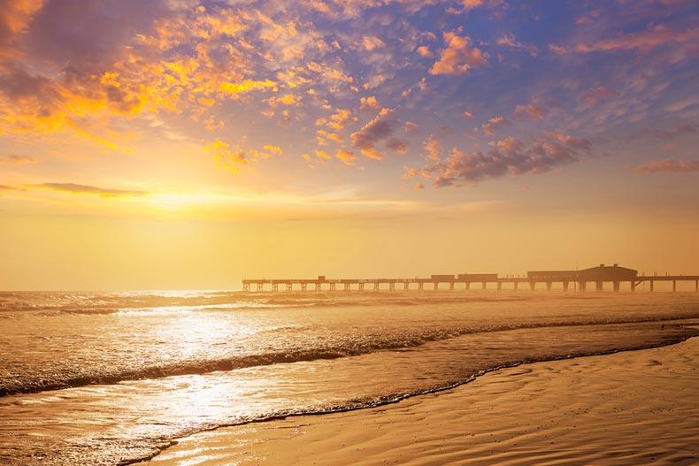 A pier in the distance along the shore of Daytona Beach in Florida