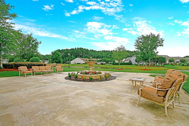 An outdoor seating area and a fountain at Del Webb at Cane Bay in Summerville, South Carolina