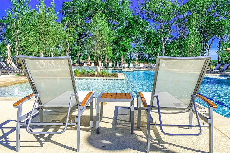 Chairs beside the outdoor pool at Del Webb at Trinity Falls in McKinney, Texas
