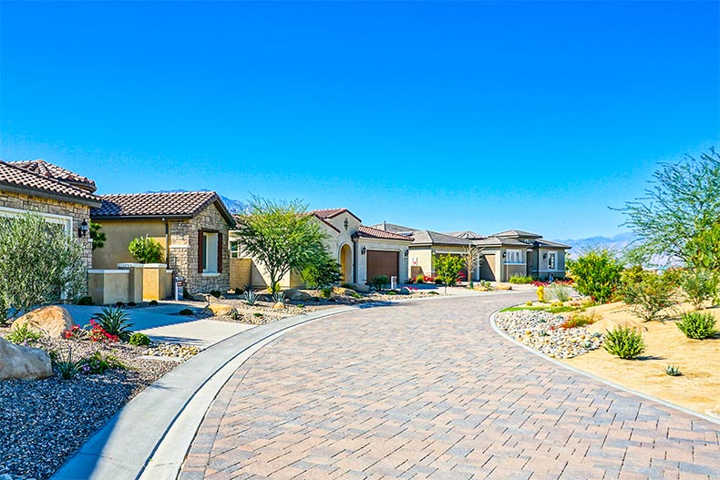 Homes lining a cobblestone street at Del Webb Rancho Mirage in Rancho Mirage, California