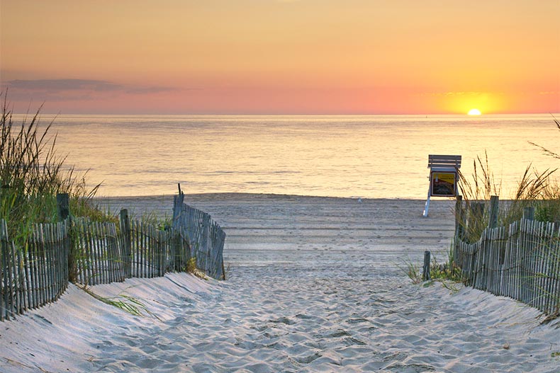 Sandy walkway onto a Delaware beach as the sunrise on the Atlantic Ocean