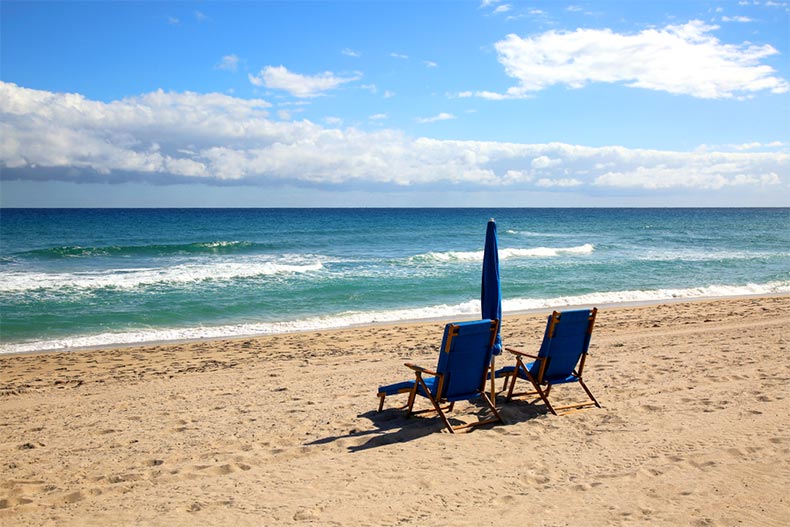 Two lounge chairs and an umbrella on the beach in Delray, Florida