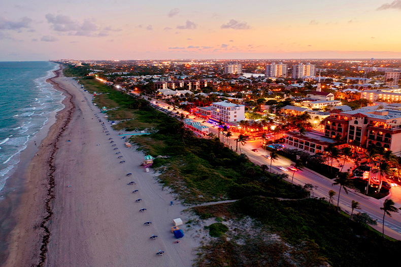 Aerial view of a beach and business strip at sunset in Delray Beach, Florida